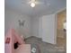 Neutral bedroom featuring carpet, a teepee, white doors, and access to hallway at 8065 Stoneham Ct, Matthews, NC 28105