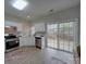 Clean and modern kitchen with white cabinets, stainless steel appliances, and a sliding glass door at 8065 Stoneham Ct, Matthews, NC 28105