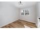 Cozy bedroom showcasing hardwood floors, natural lighting, and a modern ceiling fan at 915 Tilden Rd, Charlotte, NC 28214