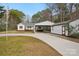 Charming single-story home with white siding, red shutters, covered parking and a long, curved driveway at 985 Dunlap Roddey Rd, Rock Hill, SC 29730