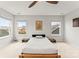 Bright, minimalist bedroom featuring neutral walls, carpet floors, and natural light from two large windows at 1201 Township Pkwy, Belmont, NC 28012