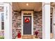 Stone clad porch with colorful wreath and covered entry at 1201 Township Pkwy, Belmont, NC 28012