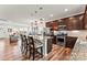 Open concept kitchen and living room area boasts hardwood floors, stainless appliances, granite countertop and pendant lighting at 1201 Township Pkwy, Belmont, NC 28012