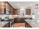 Modern kitchen with stainless steel appliances and tiled backsplash at 1201 Township Pkwy, Belmont, NC 28012