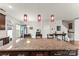 Granite kitchen island and pendant lights, adjacent to the staircase and dining area at 1201 Township Pkwy, Belmont, NC 28012