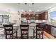 A modern kitchen features stainless steel appliances, granite countertops, and a central island with barstool seating at 1201 Township Pkwy, Belmont, NC 28012