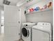 Laundry room with white washer and dryer and overhead storage at 1201 Township Pkwy, Belmont, NC 28012
