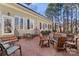 Backyard brick patio with outdoor seating, a fire pit, and mature trees creating a private oasis at 1335 E Marion St, Shelby, NC 28150