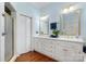 Bathroom with a large white vanity, double sinks, gold fixtures, and a separate shower stall at 1335 E Marion St, Shelby, NC 28150