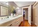 Bathroom featuring dual sinks, large mirror, and decorative features at 1335 E Marion St, Shelby, NC 28150