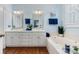 Bright bathroom featuring a large white vanity, double sinks, mirrors, and a soaking tub at 1335 E Marion St, Shelby, NC 28150