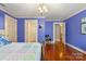 Large blue bedroom with hardwood floors, neutral trim, and ensuite bath at 1335 E Marion St, Shelby, NC 28150