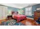 Comfortable bedroom with wood floors, colorful rug, and bright window with shutters at 1335 E Marion St, Shelby, NC 28150