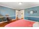 Bedroom with blue striped wallpaper and access to bathroom and stairs at 1335 E Marion St, Shelby, NC 28150