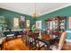 Stately dining room with dark wood table, green walls, and lovely display cabinet at 1335 E Marion St, Shelby, NC 28150