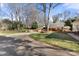 Long driveway leading to a home with a brick carport and mature trees dotting the manicured lawn at 1335 E Marion St, Shelby, NC 28150