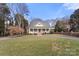 Spacious front yard with a circular driveway leading to a quaint home with inviting front porch at 1335 E Marion St, Shelby, NC 28150