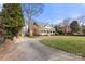 Charming brick home with a welcoming front porch, well-manicured lawn, and mature trees at 1335 E Marion St, Shelby, NC 28150