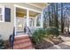 Inviting front porch with classic columns, brick steps, and a charming entry door at 1335 E Marion St, Shelby, NC 28150