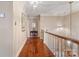 Upstairs hallway featuring hardwood floors, a decorative light fixture, and neutral walls at 1335 E Marion St, Shelby, NC 28150