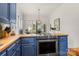 Kitchen featuring a stainless steel range and stylish blue cabinets at 1335 E Marion St, Shelby, NC 28150