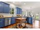 Bright kitchen with blue cabinets, stainless steel appliances, and a wooden island at 1335 E Marion St, Shelby, NC 28150