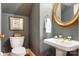 Charming powder room featuring patterned wallpaper, decorative mirror, and a pedestal sink at 1335 E Marion St, Shelby, NC 28150