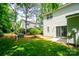 Lush backyard with a sliding door, patio, and green grass at 1748 Pergola Pl, Charlotte, NC 28213