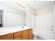 Bathroom with double sinks, a shower-tub combo, and a storage closet at 1748 Pergola Pl, Charlotte, NC 28213
