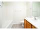 Bathroom with a shower/tub combo, oak cabinetry, and white fixtures at 1748 Pergola Pl, Charlotte, NC 28213