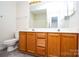 Well-lit bathroom with a double sink vanity and framed mirror at 1748 Pergola Pl, Charlotte, NC 28213