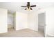 Bright bedroom with neutral carpet and walls, complete with a ceiling fan and closet at 1748 Pergola Pl, Charlotte, NC 28213