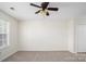 Neutral bedroom with a ceiling fan, carpet flooring, and closet at 1748 Pergola Pl, Charlotte, NC 28213