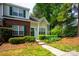 Lovely townhome featuring a blend of brick and siding, enhanced by verdant foliage and eye-catching green shutters at 1748 Pergola Pl, Charlotte, NC 28213