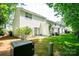 Back exterior view with landscaping, hardscape and green space at 1748 Pergola Pl, Charlotte, NC 28213