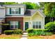 Charming townhome with a mix of brick and siding, complemented by lush landscaping and vibrant green shutters at 1748 Pergola Pl, Charlotte, NC 28213
