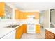 A bright kitchen featuring lots of counter space and oak cabinetry at 1748 Pergola Pl, Charlotte, NC 28213
