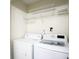 Bright laundry room with white appliances and ample shelving at 1748 Pergola Pl, Charlotte, NC 28213