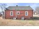 Brick home featuring windows, an AC unit and updated backyard at 1902 Old Wilkesboro Rd, Statesville, NC 28625