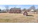View of the home's backyard showing a brick house and grassy area at 1902 Old Wilkesboro Rd, Statesville, NC 28625