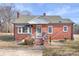 Quaint red brick house with a covered porch and classic architectural details at 1902 Old Wilkesboro Rd, Statesville, NC 28625