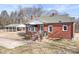 Exterior of a red brick home with a covered carport and well-kept lawn at 1902 Old Wilkesboro Rd, Statesville, NC 28625