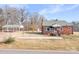Charming red brick home featuring a covered carport and a well-maintained front yard at 1902 Old Wilkesboro Rd, Statesville, NC 28625