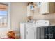 Practical laundry area equipped with a washer, dryer, and storage shelves at 1902 Old Wilkesboro Rd, Statesville, NC 28625