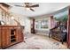 Comfortable living room showcasing a classic design with a ceiling fan and large window at 1902 Old Wilkesboro Rd, Statesville, NC 28625