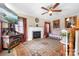Inviting living room featuring a fireplace, ceiling fan, and decorative rug at 1902 Old Wilkesboro Rd, Statesville, NC 28625