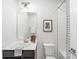 Functional bathroom featuring a vanity with storage, a toilet, and a shower/tub combo with a decorative shower curtain at 232 Parkwood Ave, Charlotte, NC 28206