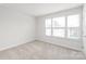 Bright bedroom with carpeted floors, three windows and white trim at 232 Parkwood Ave, Charlotte, NC 28206