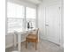 Sunlit home office area with a white desk, comfortable chair, and large windows providing natural light and a pleasant view at 232 Parkwood Ave, Charlotte, NC 28206