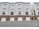 Exterior townhome showcasing the siding facade, brick trim and garage at 232 Parkwood Ave, Charlotte, NC 28206